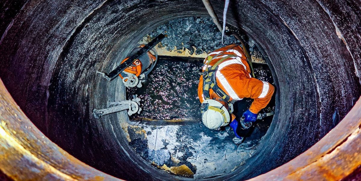 Operator working within maintenance hole 