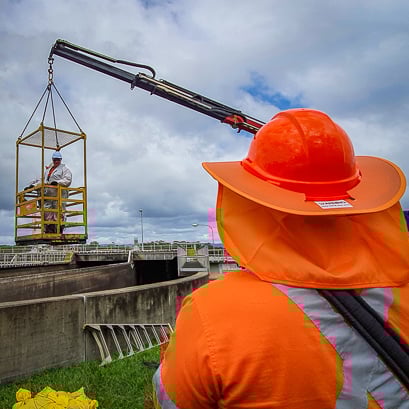 A-PMA-team-member-operates-a-man-cage-to-help-a-team-mate-egress-from-a-wastewater-asset