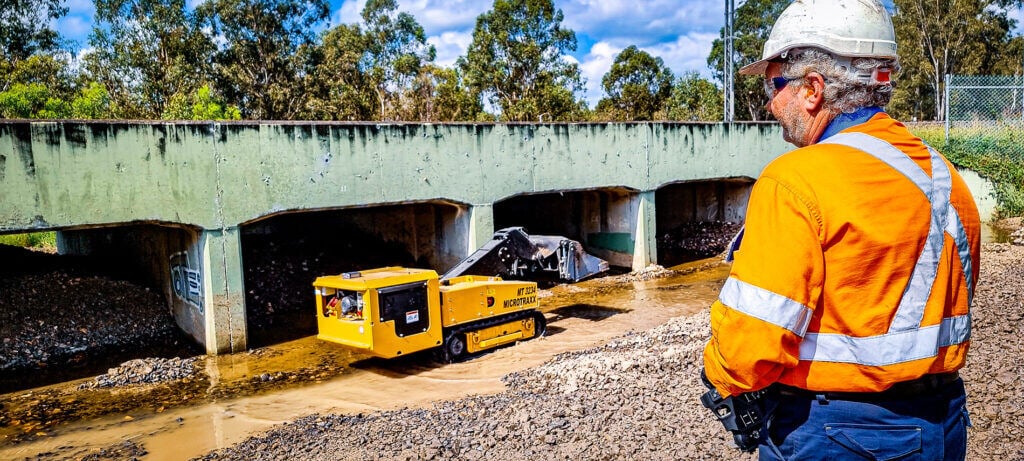 MicroTraxx-Culvert-Cleaner-emptying-load-1024x461